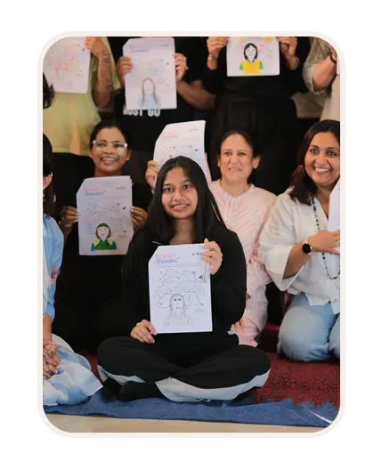 Healing Through Art participants holding their artwork
